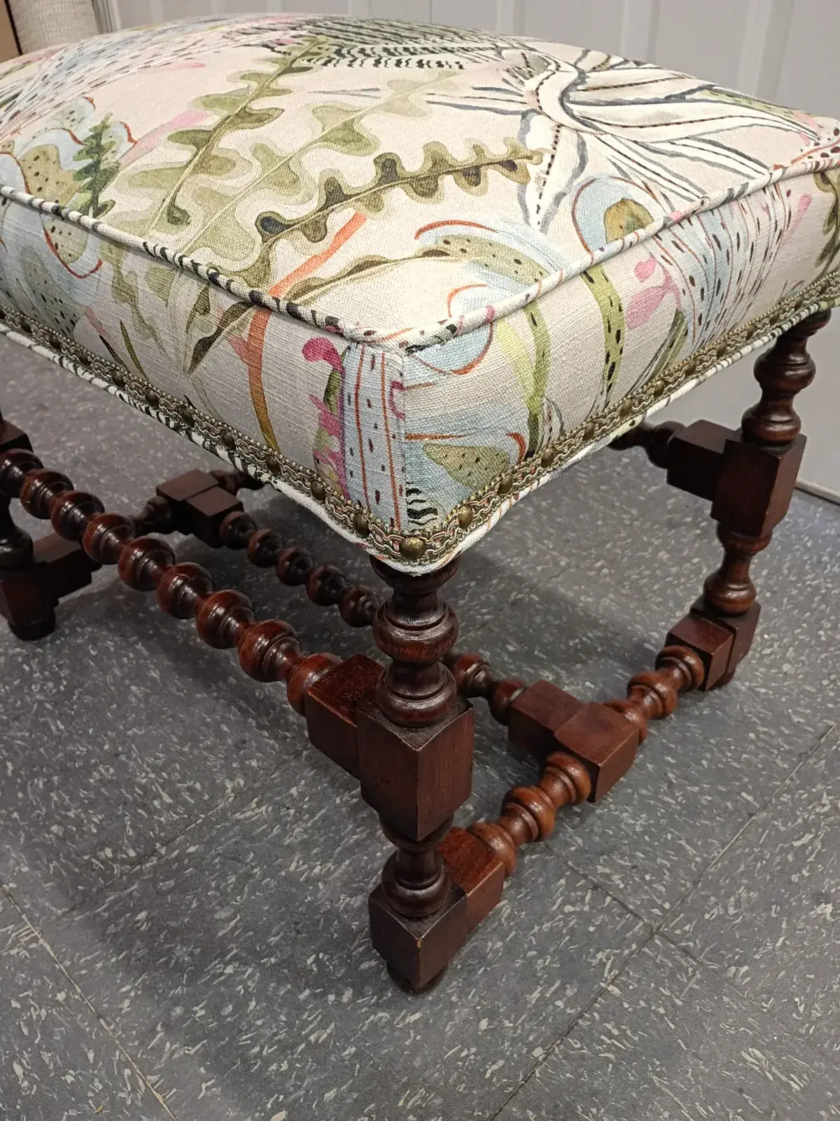 Bench with turned wood legs and a boxed top in colorful botanical print