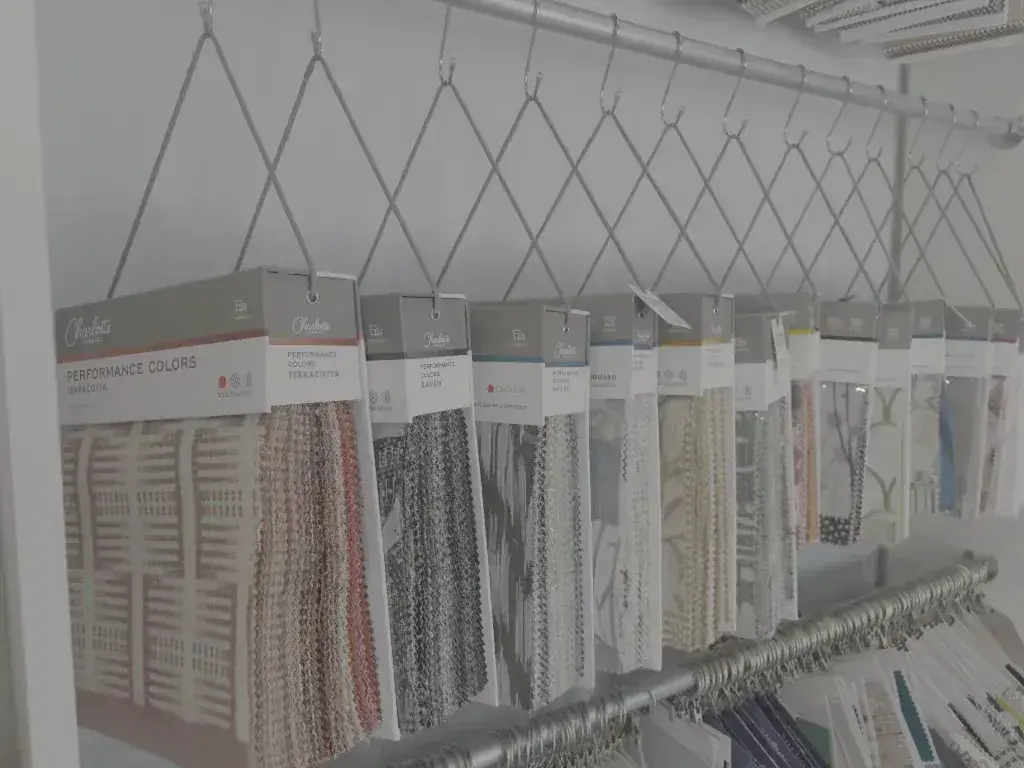 Hanging fabric sample books on a rail at Seabreeze Upholstery