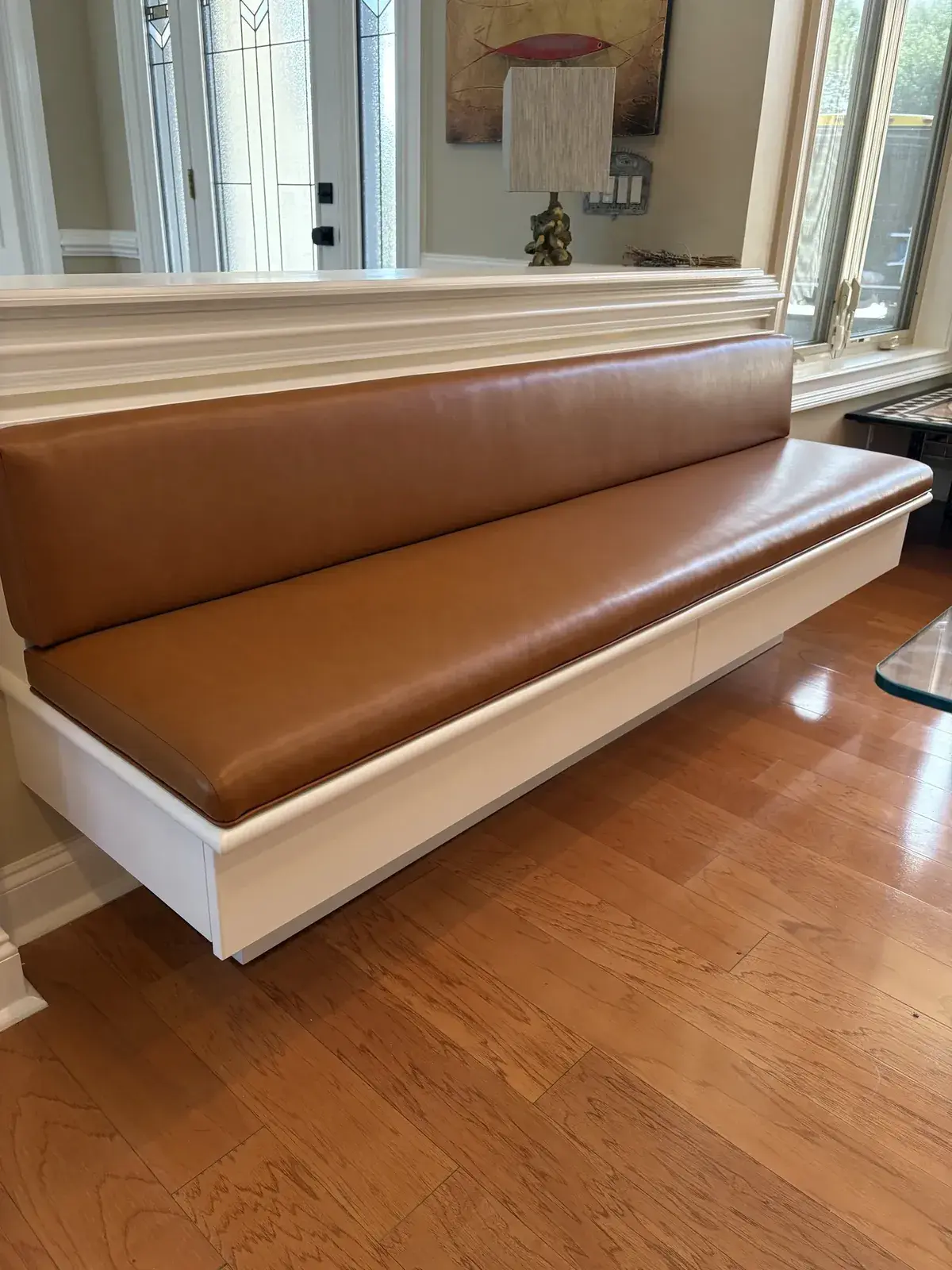 Built-in window bench with a long caramel-colored seat cushion