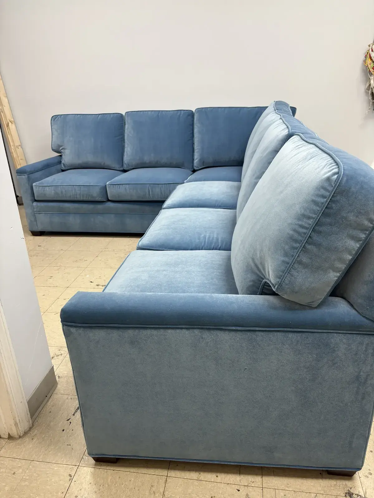 Sectional sofa reupholstered in slate-blue fabric